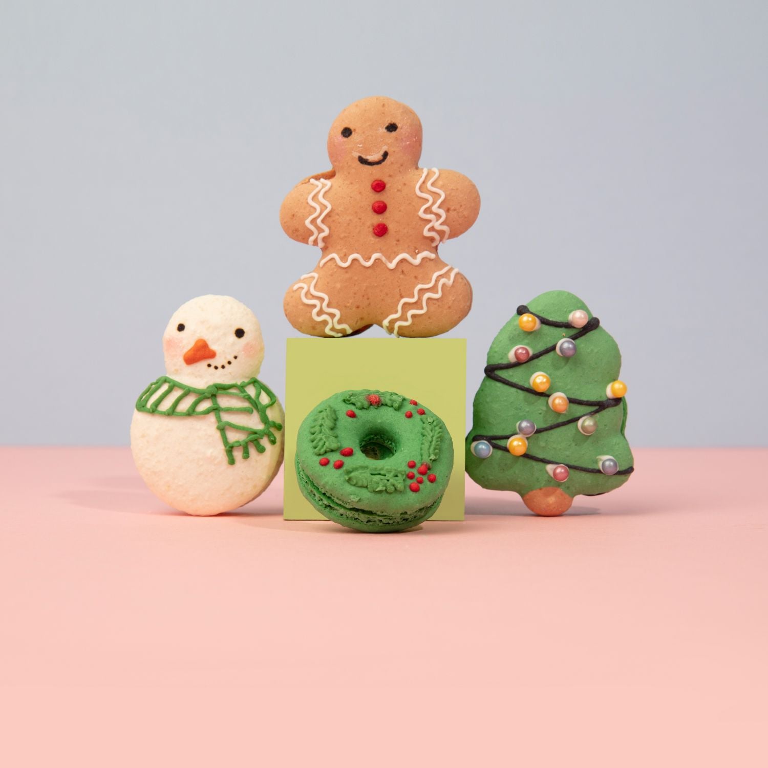 Christmas macarons including a gingerbread man, snowman, wreath, and Christmas tree at Oh La La! Macarons