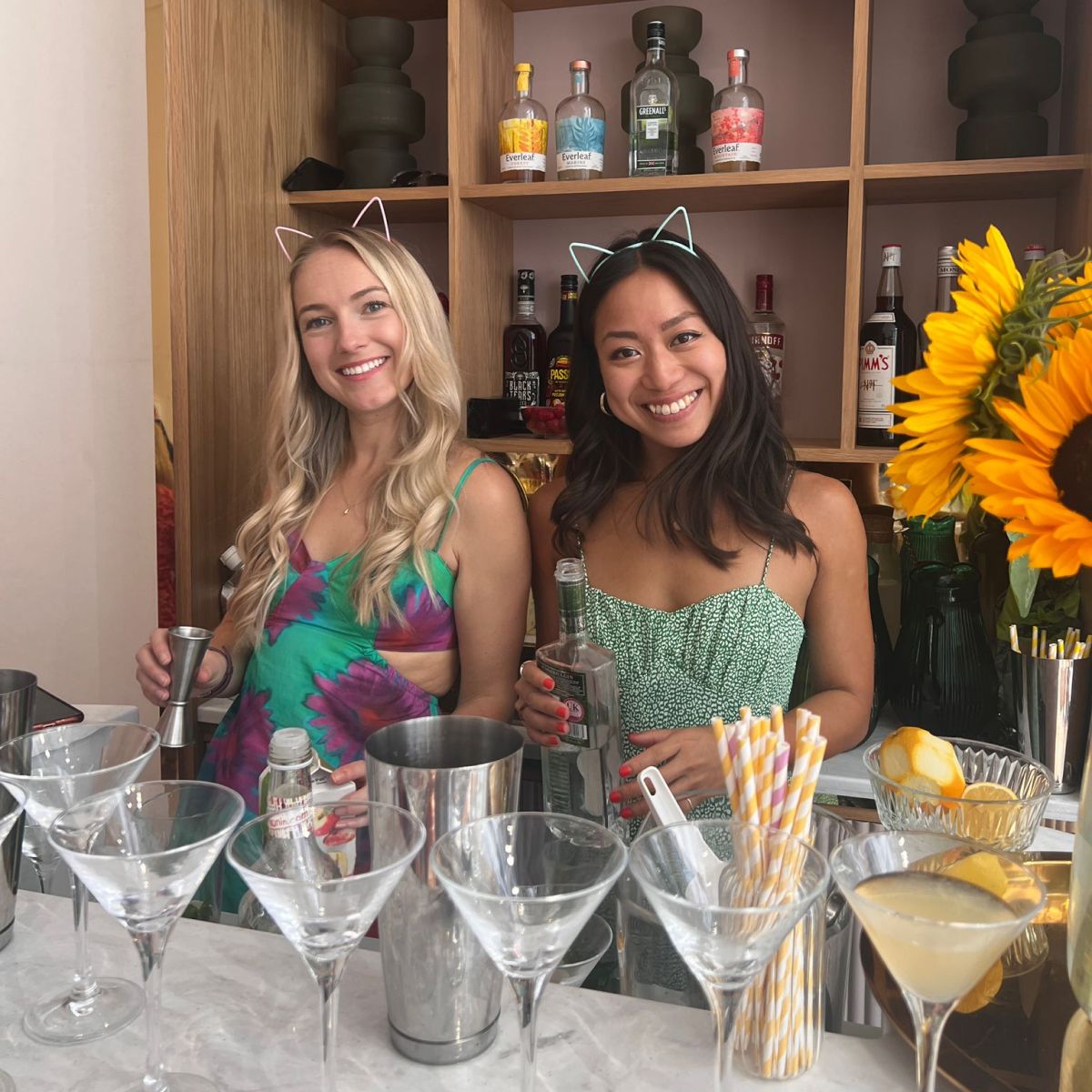 Two women mixing drinks behind the counter at a hen party at Oh La La! Macarons