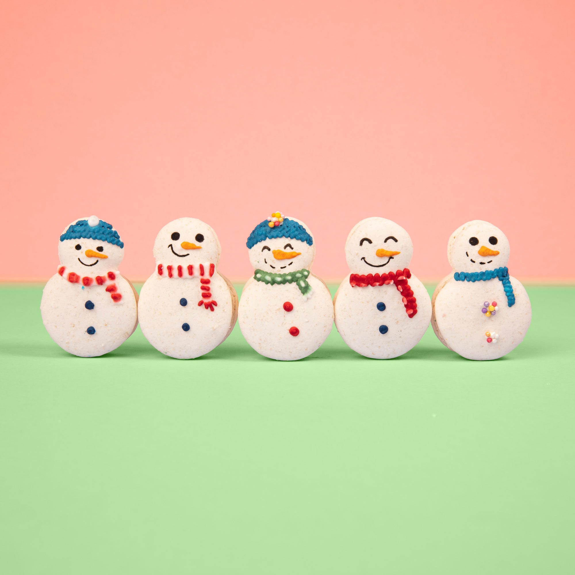 Snowmen macarons with different knitted hats and scarves